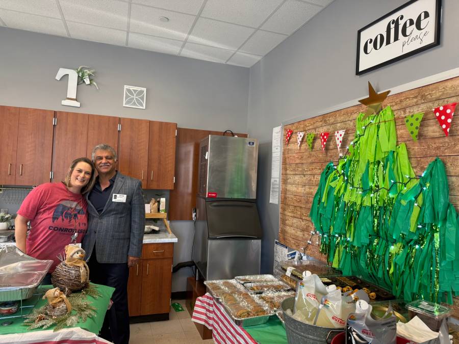Volunteers serving food at an event in a school computer lab setting.
