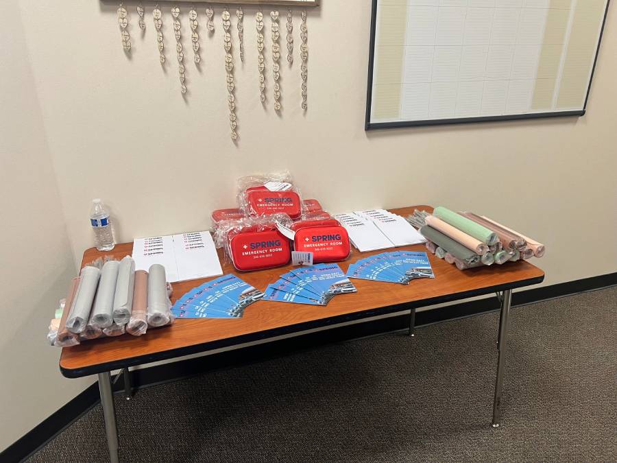 Volunteers serving food at an event in a school computer lab setting.
