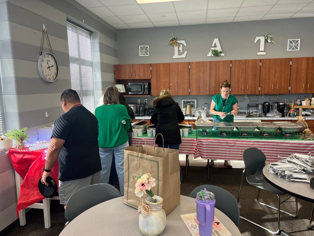 Front view of a red-brick elementary school building under a clear blue sky.